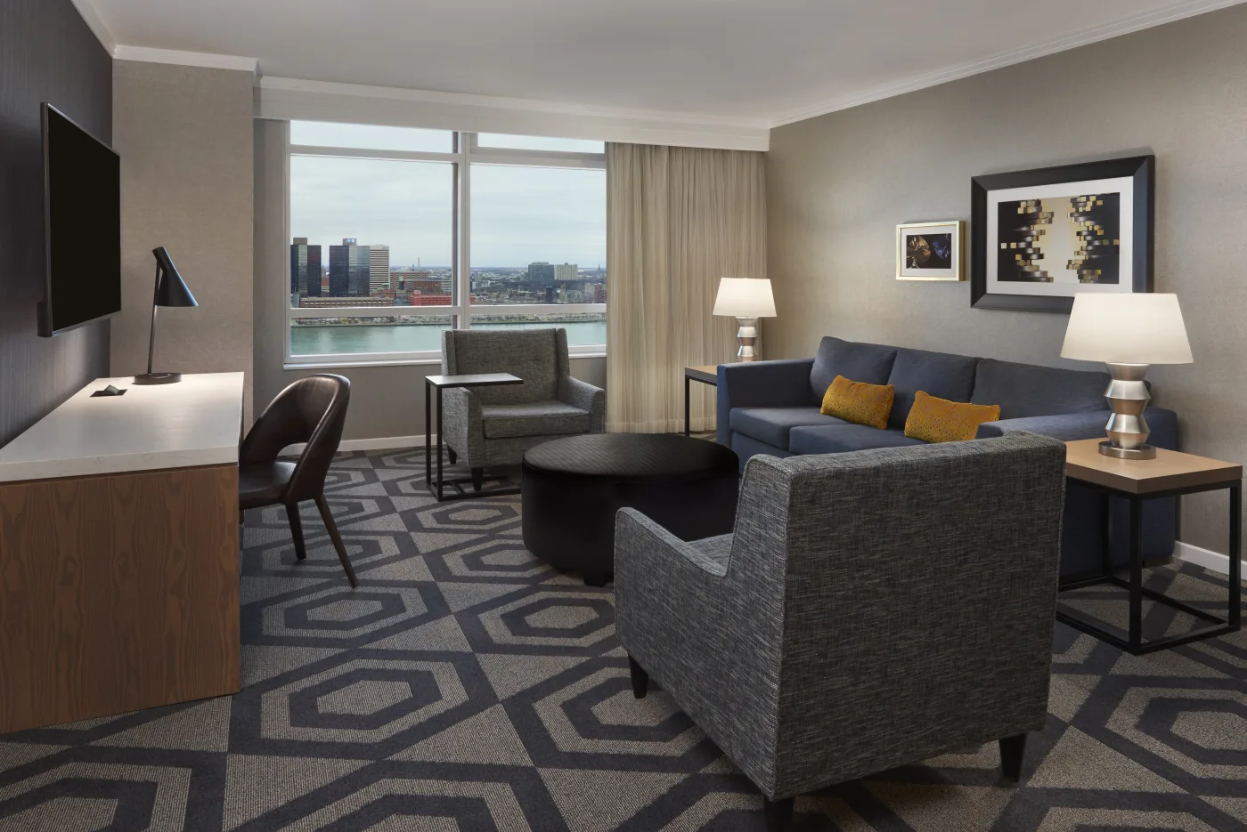 Forum Tower suite living area with large windows overlooking the river