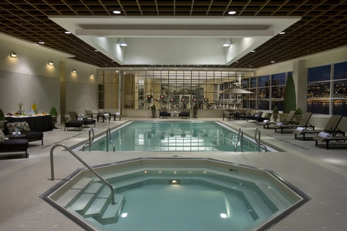 Caesars Windsor indoor pool with lounge chairs and tall windows